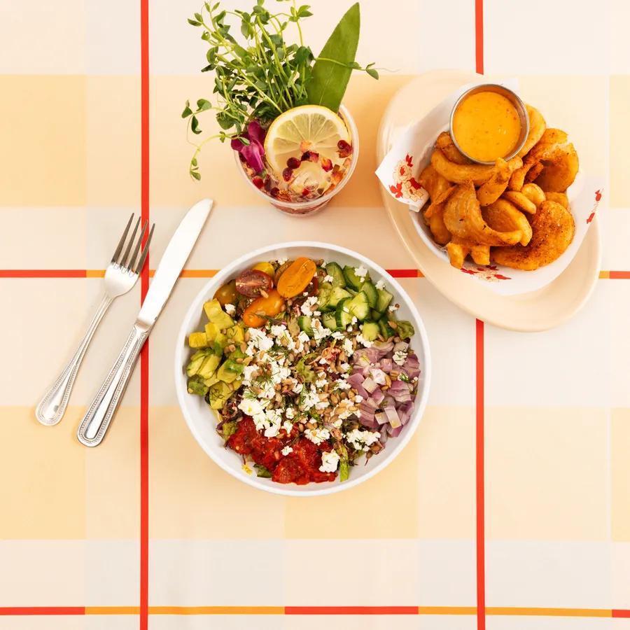 A colorful salad with vegetables, cheese and herbs, accompanied by seasoned potatoes and a drink at Safta's Table (Photo: Safta's Table) A colorful salad with vegetables, cheese and herbs, accompanied by seasoned potatoes and a drink at Safta's Table