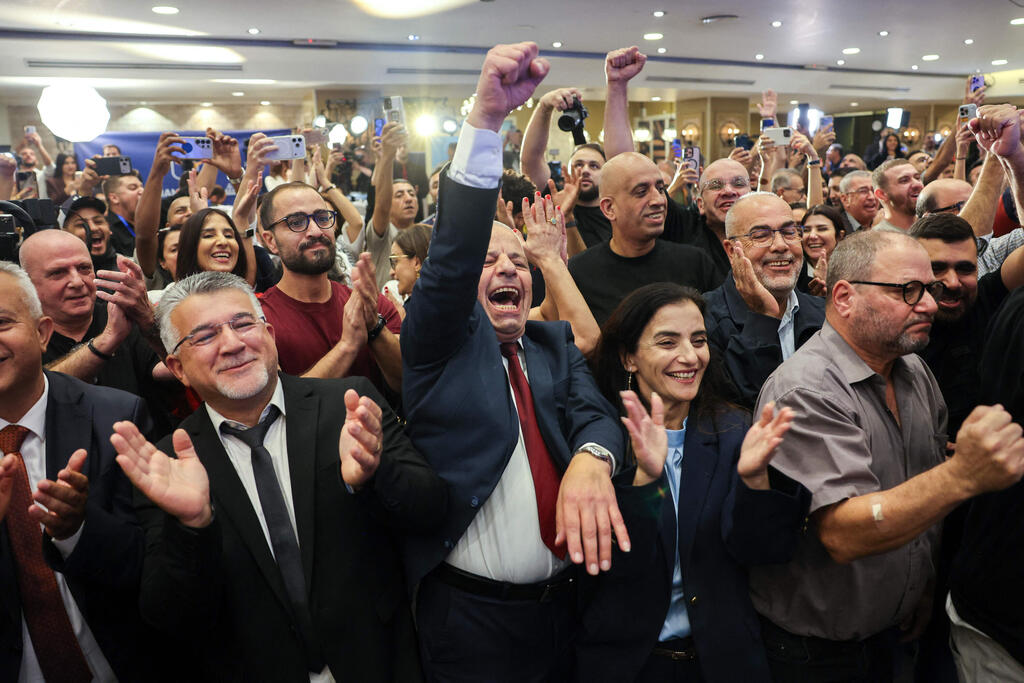 Supporters celebrate at the predominantly Arab Joint List alliance's headquarters in Nazareth as exit poll results are announced (Photo: AHMAD GHARABLI / AFP) נצרת