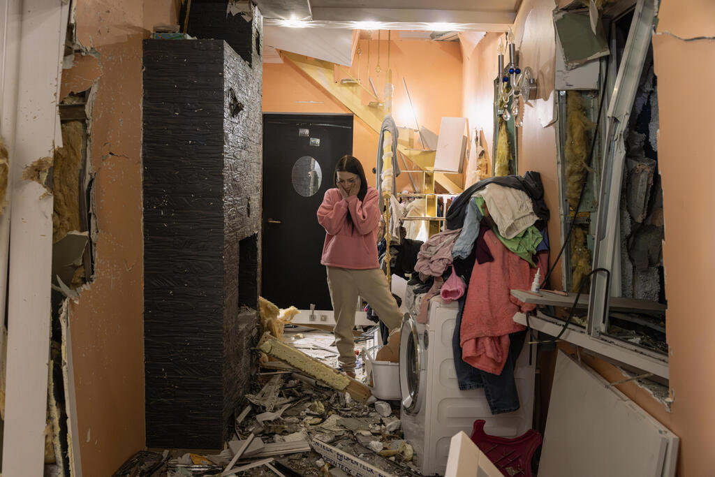 Natalya reacts as she looks at the damage inside her house following an aerial attack by Russia on Kyiv, Ukraine 