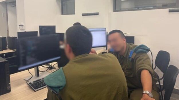 Two IDF soldiers examine computer systems during an exercise designed to identify cybersecurity vulnerabilities and test military defenses (Photo: IDF) IDF technology cadets collaborate during a five-day cyberwarfare exercise at the military's communications and technology campus in southern Israel