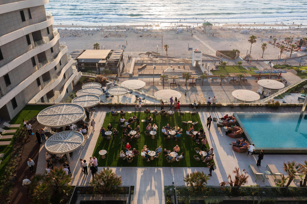 Residents and guests gather for a rooftop event overlooking the Mediterranean Sea at SEA ONE in Rishon LeZion (Photo: Oranim Group) Residents and guests gather for a rooftop event overlooking the Mediterranean Sea at SEA ONE in Rishon LeZion