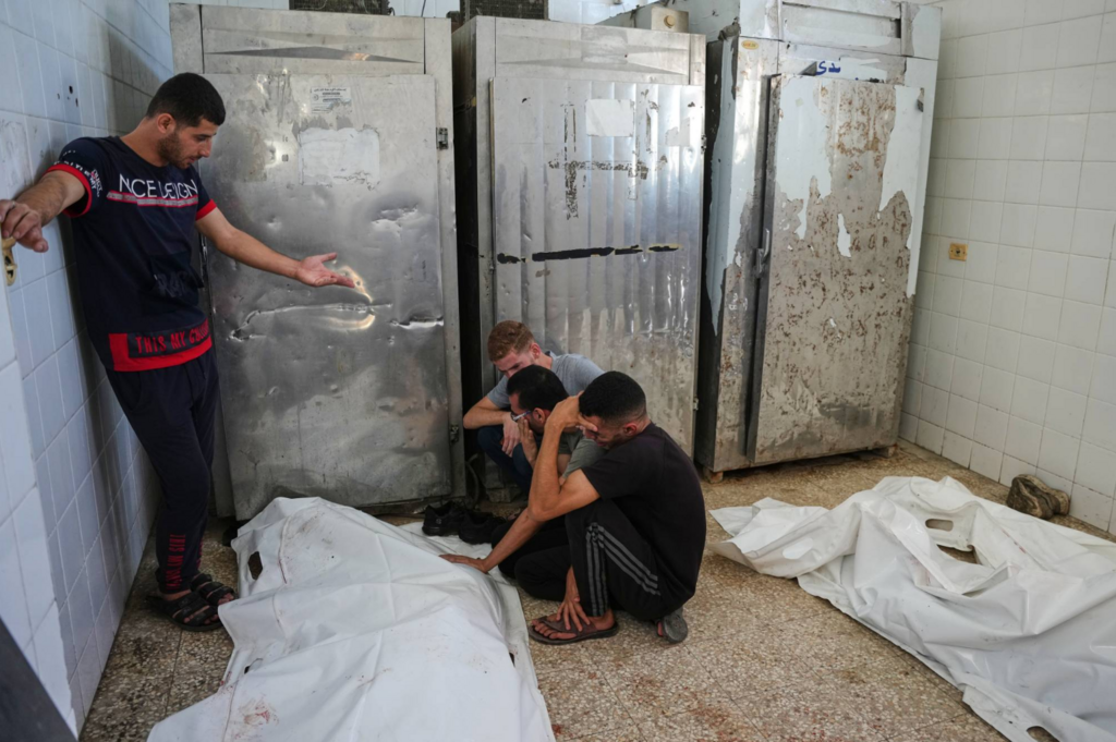 Palestinians weep in front of a body at the morgue of Al-Aqsa Hospital in Deir al-Balah in the central Gaza Strip on Thursday (Photo: AP) Palestinians weep in front of a body at the morgue of Al-Aqsa Hospital in Deir al-Balah in the central Gaza Strip on Thursday
