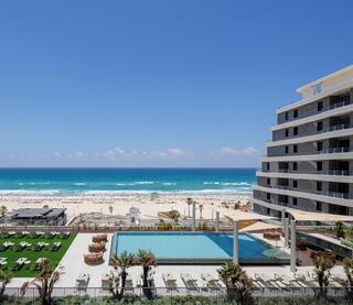 SEA ONE's rooftop swimming pool overlooks Rishon LeZion's beach, with the Mediterranean just beyond the residential complex 