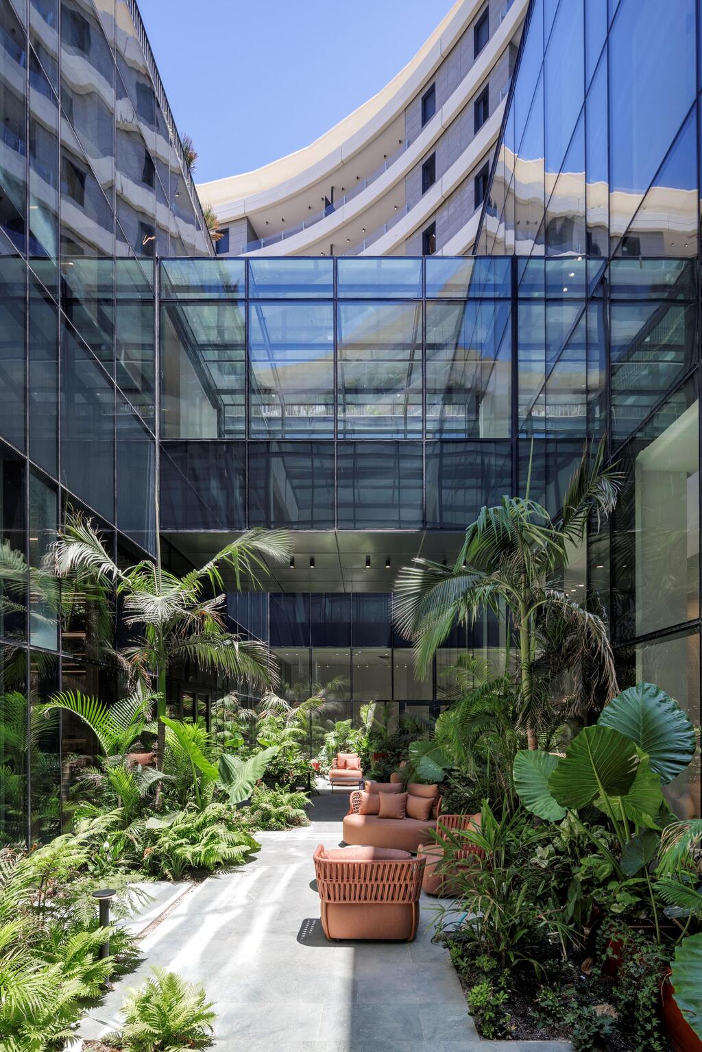 A landscaped patio with outdoor seating connects SEA ONE's residential buildings and recreational areas (Photo: Eran Turgeman) A landscaped patio with outdoor seating connects SEA ONE's residential buildings and recreational areas