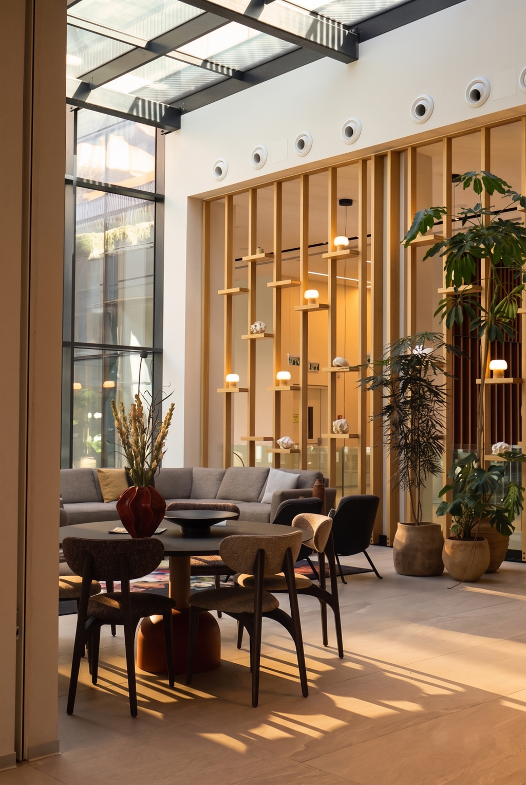 Floor-to-ceiling glass walls and warm wooden finishes define one of SEA ONE's communal lounges (Photo: Rahav Media) Floor-to-ceiling glass walls and warm wooden finishes define one of SEA ONE's communal lounges