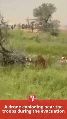 A drone exploding near the troops during the evacuation