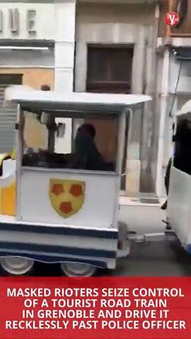 Masked rioters seize control of a tourist road train in Grenoble and drive it recklessly past police officers