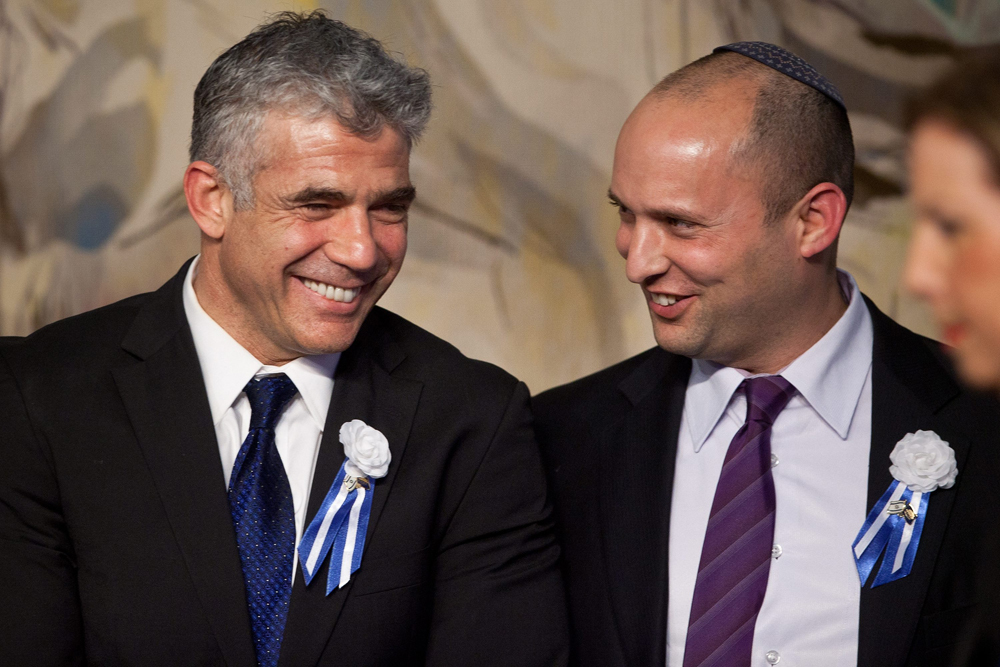 Yesh Atid head Yair Lapid and Naftali Bennett during the inauguration of the 19th Knesset 
