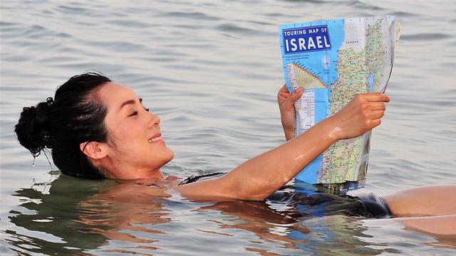 A tourist floating in the water at the Dead Sea (Image: Shutterstock) A tourist floating in the water at the Dead Sea