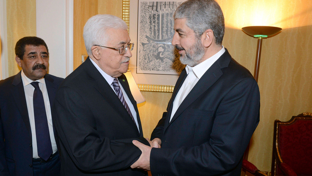 Fatah chief and Palestinian president Mahmoud Abbas and Hamas political leader Khaled Mashal during peace talks between the two rival groups in Qatar in 2014 