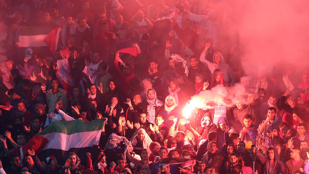 Fans hoisting Palestinian flags in Qatar 