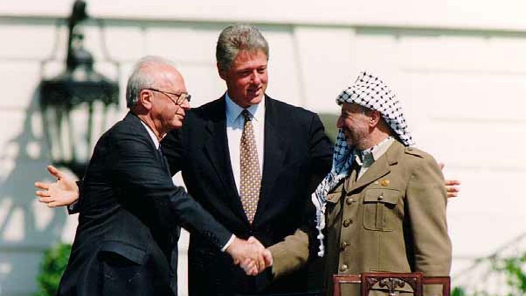 Prime Minister Yitzhak Rabin, U.S. President Bill Clinton and PLO Chairman Yasser Arafat during the signing of the Oslo Accords at the White House in 1993 