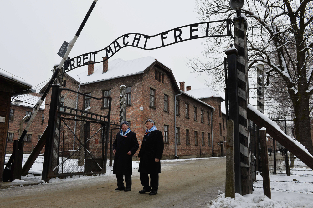 Holocaust survivors at the entrance to the Auschwitz concentration camp in 2015 
