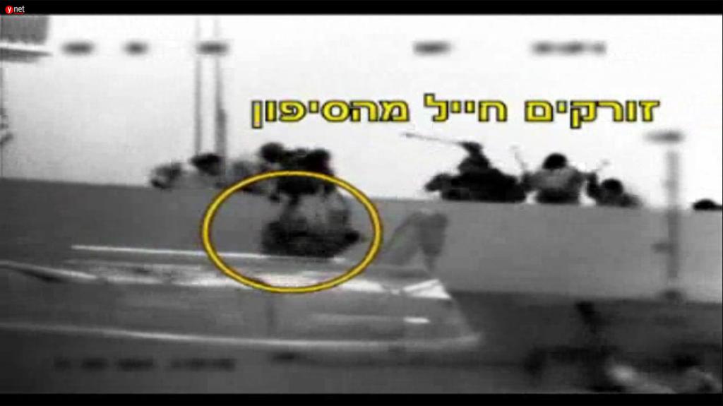 A still image from footage of the 2010 Gaza flotilla raid showing an IDF soldier being thrown overboard