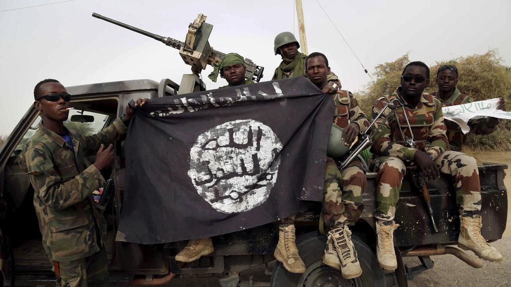 Nigerian soldiers holding a Boko Haram flag 