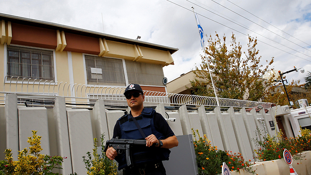 An armed security guard stands outside the Israeli embassy in Ankara 