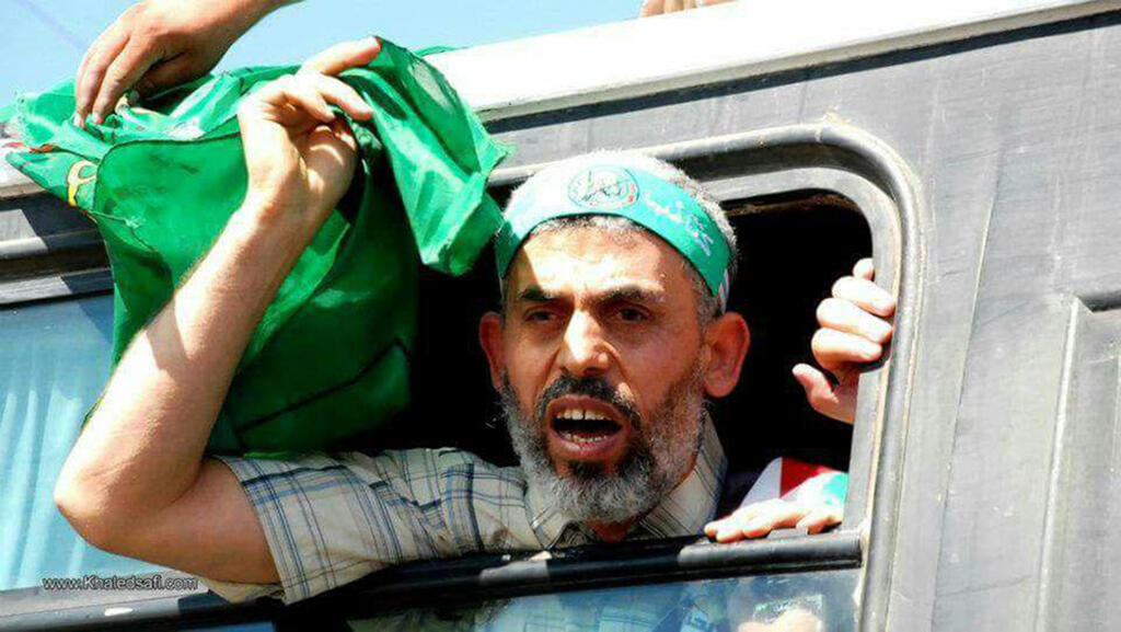 Yahya Sinwar waves a Hamas flag as he is released from an Israeli prison as part of the 2011 prisoner swap deal 