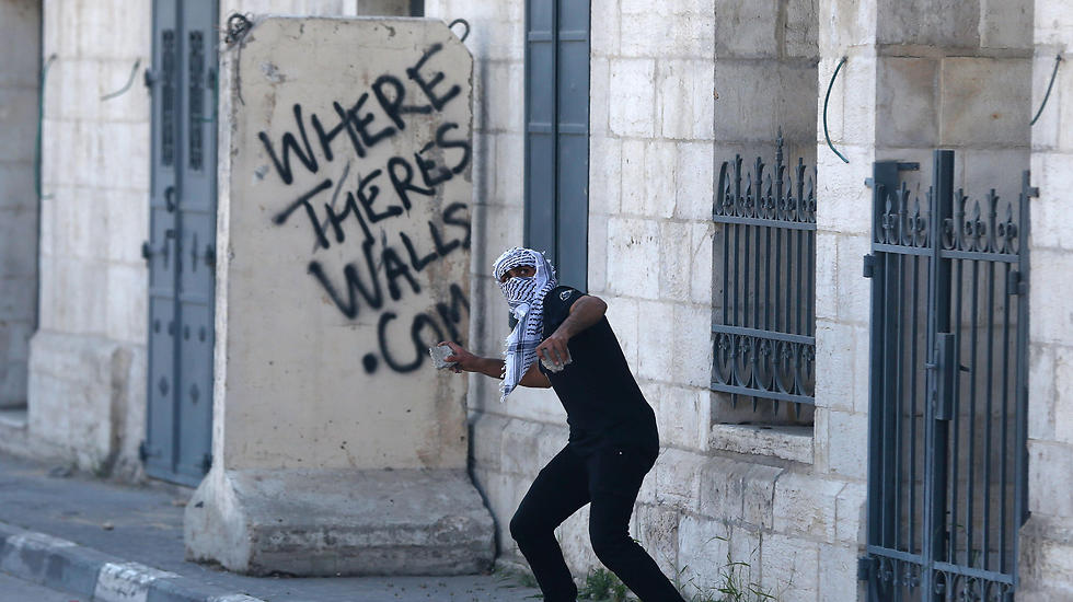 A Palestinian hurling rocks at IDF soldiers 