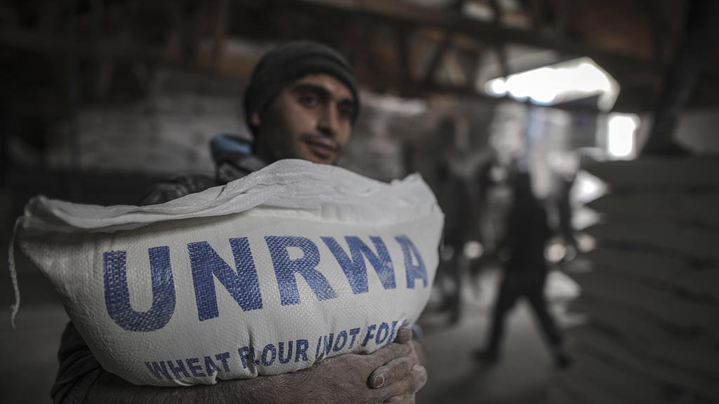 Palestinian in Gaza receiving UNRWA food aid 