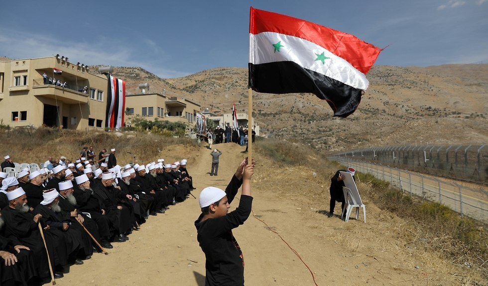 Druze residents of the Golan Heights attend a rally in support of Syrian President Assad in Majdal Shams