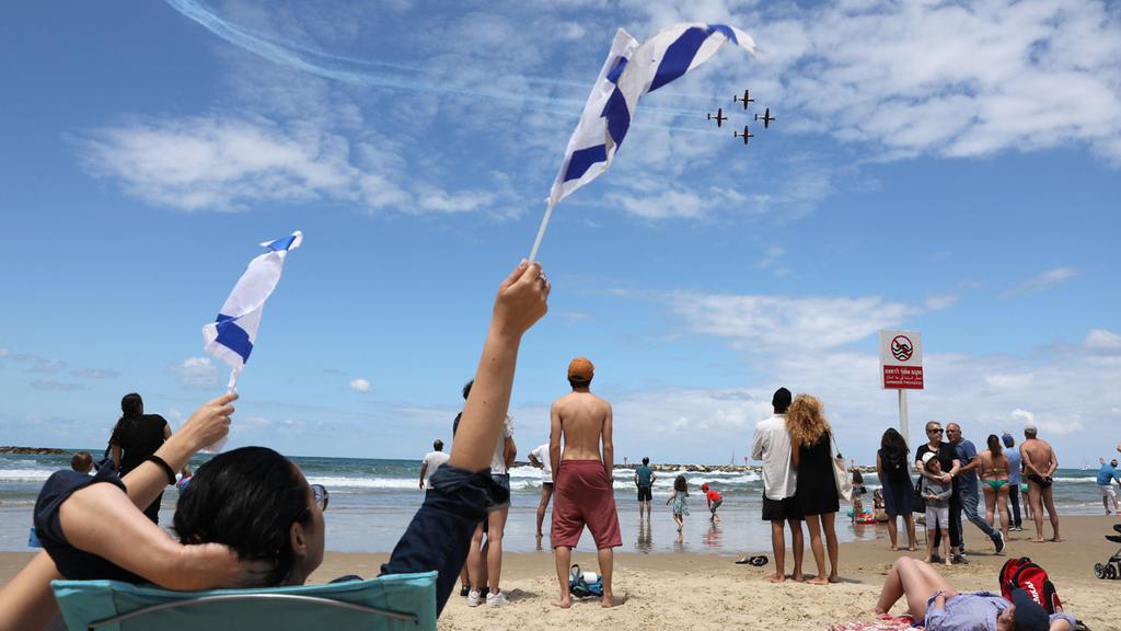 Israelis on Tel Aviv beach watching last year's Independence Day aerial display (Photo: EPA) המטס בתל אביב