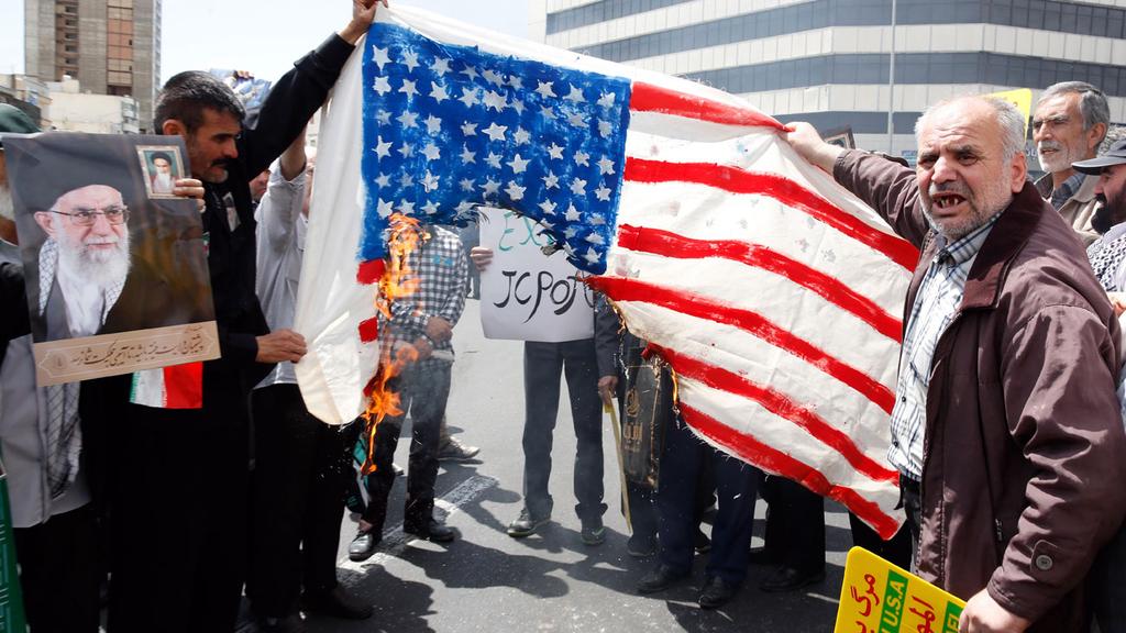  Protesters in Iran burn American flag 
