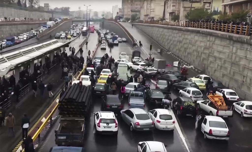 Iranian protesters block a road during a demonstration in Tehran against an increase in gasoline prices, Nov. 16, 2019 