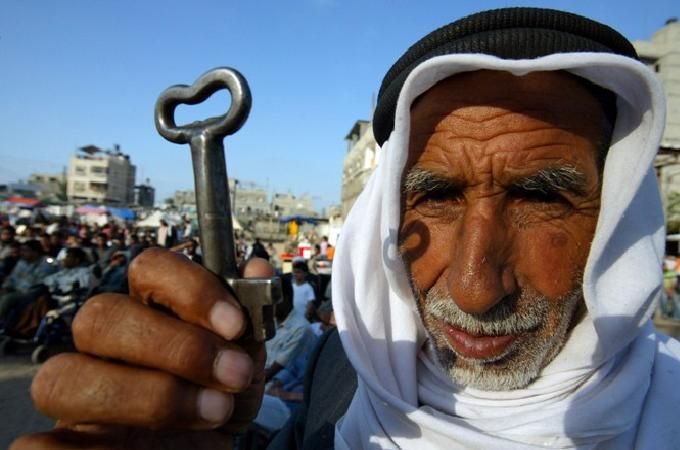 A Palestinian refugee in Lebanon holding the key to his former house in Israel