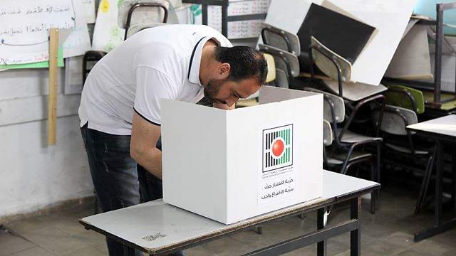 A Palestinian votes in municipal elections in the West Bank in 2017 