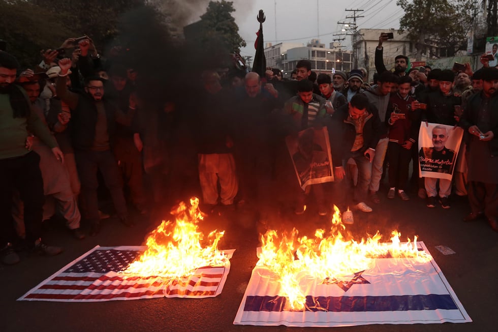 Iranians in Tehran burn American and Israeli flags to protest the killing of Qasem Soleimani by the U.S. 