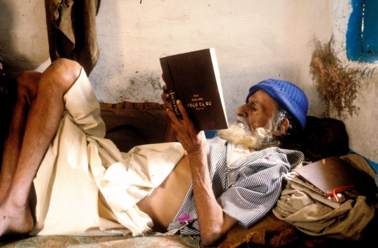 An elderly Jewish Yemenite man reads a religious book upside down, year unclear 