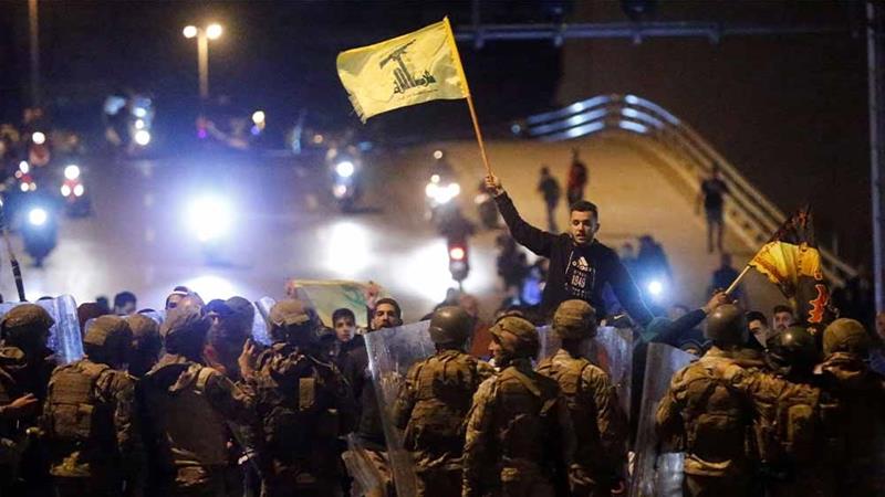 Hezbollah and Amal demonstrators clashing with police in Beirut 