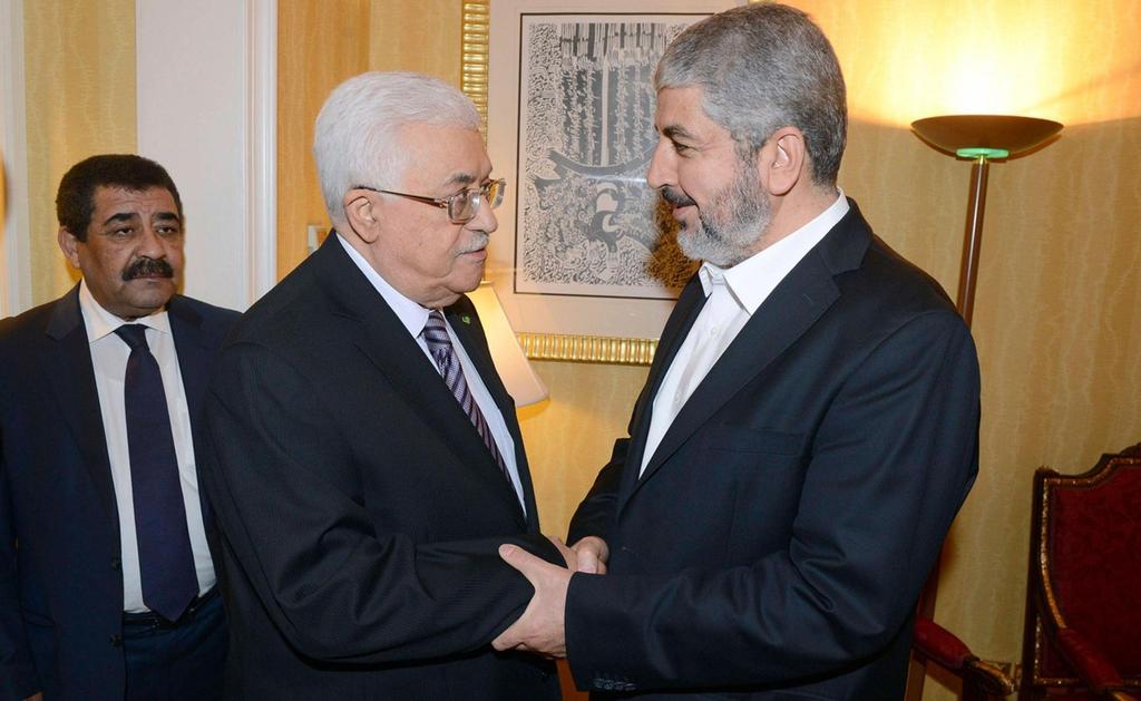Palestinian President Mahmoud Abbas and Hamas political leader Khaled Mashal meeting in Cairo in 2011 