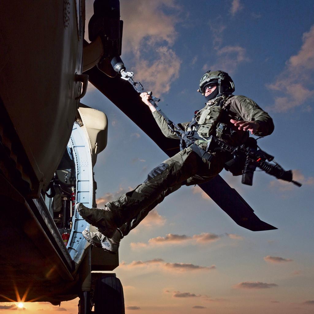 Guy in action on a Black Hawk helicopter 