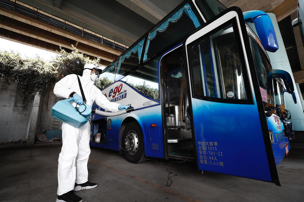 Disinfecting buses in Taiwan in the early days of the COVID-19 pandemic (Photo: EPA) חיטוי וניקוי אוטובוסים טאיוואן