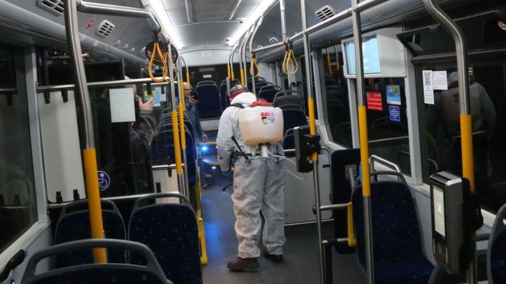 Health worker disinfecting a bus (Photo: Moti Kimchi) חיטוי אוטובוס של חברת "דן" בעקבות התפשטות נגיף הקורונה בישראל