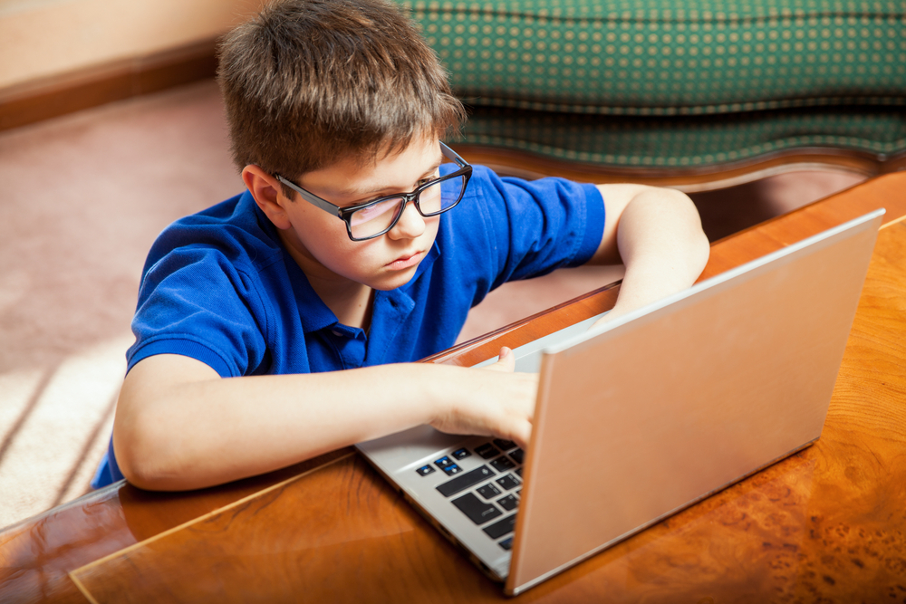 ההורים מאפשרים יותר זמן מסך (צילום: shutterstock) ילד עם מחשב נייד