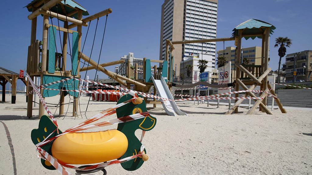 Tape keeps people out of one of Tel Aviv beach's playgrounds (Photo: AFP) חוף ים ריק תל אביב