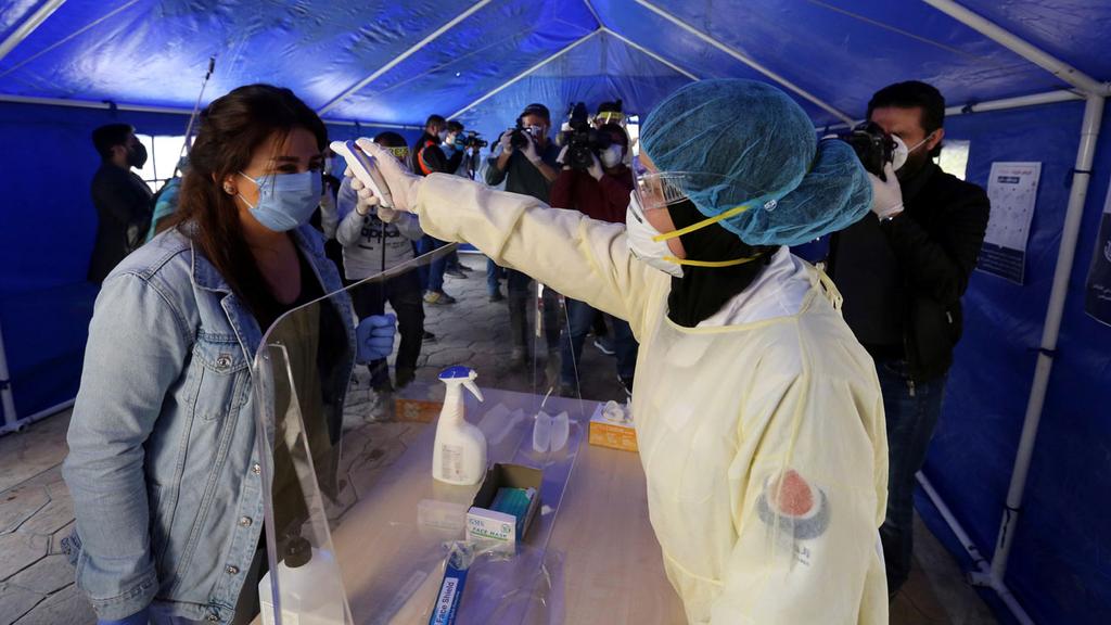 Checking for a fever, one of the signs of coronavirus, in Lebanon (Photo: Reuters) Checking for a fever, one of the signs of coronavirus, in Lebanon