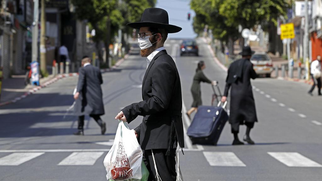 Bnei Brak residents in a city under partial lockdown (Photo: AFP) תושבי בני ברק בזמן הסגר של המשטרה
