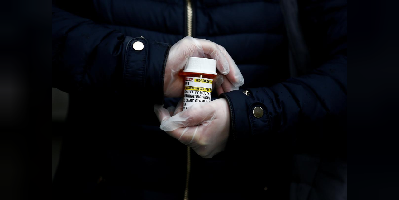 A woman in Seattle holding a bottle of hydroxychloroquine 