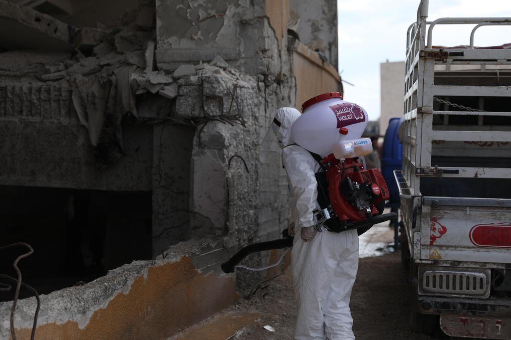 A volunteer health worker during a disinfection operation in Idlib, Syria (Photo: EPA) A volunteer health worker during a disinfection operation in Idlib, Syria