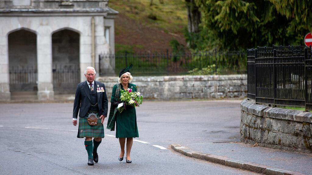 Britain's Charles, Prince of Wales and Camilla, Duchess of Cornwall walk to take part in a two-minute silence to mark the 75th anniversary of VE Day at the Balmoral War Memorial, Scotland