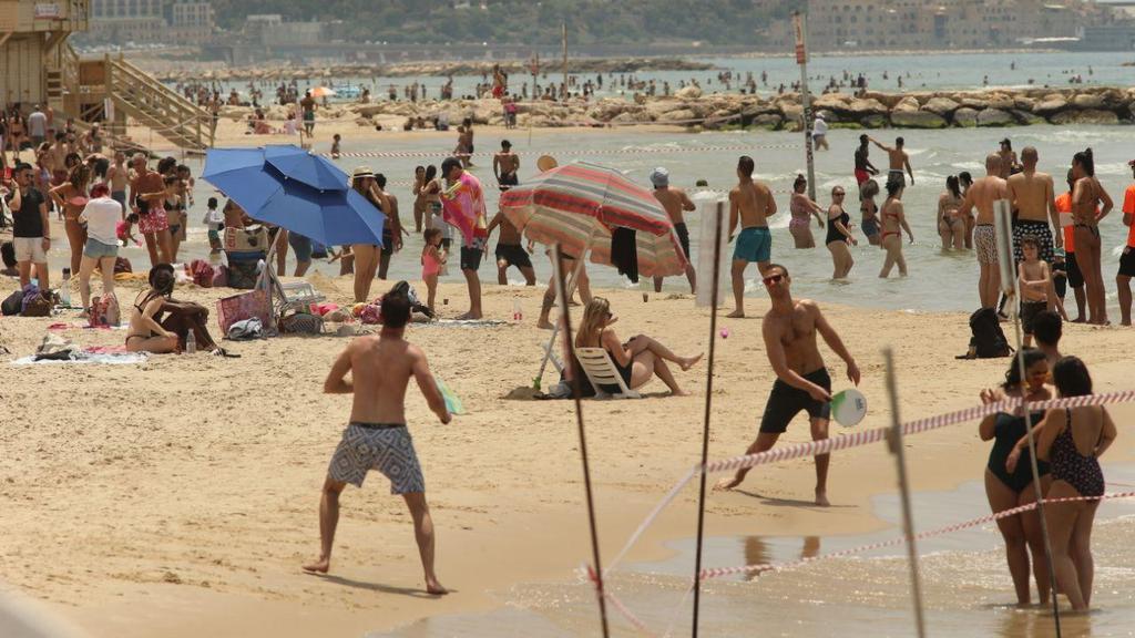 Hundreds of Israelis flock to Tel Aviv beaches over the weekend despite government's emergency coronavirus regulations (Photo: Motti Kimchi ) המונים בחופי תל אביב