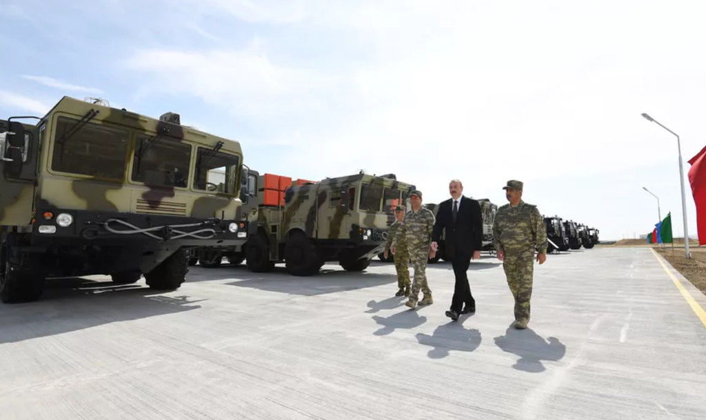 Azerbaijani President Ilham Aliyev walks in front of the Israeli-made LORA artillery system at a military base on June 11, 2018 