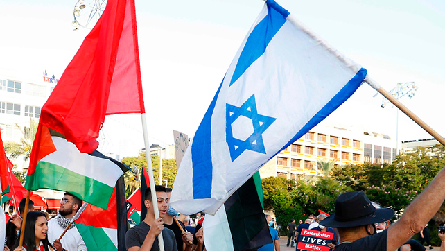 Protesters wave Israeli and Palestinian flags at a demonstration in Tel Aviv, June 2020 (Photo: AFP) הפגנה מחאה שמאל נגד סיפוח שטחים דמוקרטיה כיכר רבין תל אביב