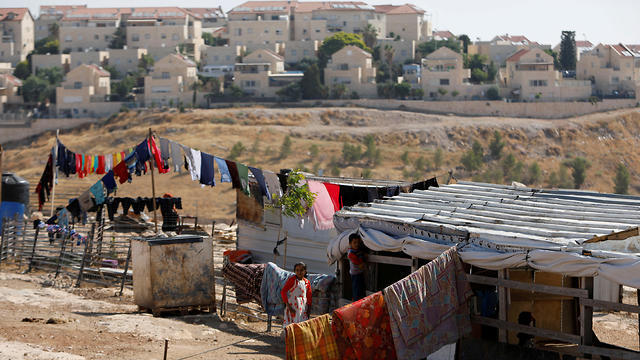 Palestinian children play outside their dwelling in al-Eizariya with the West Bank settlement of Maale Adumim in the background (Photo: Courtesy) Palestinian children play outside their dwelling in al-Eizariya town with the Jewish settlement of Maale Adumim in the background