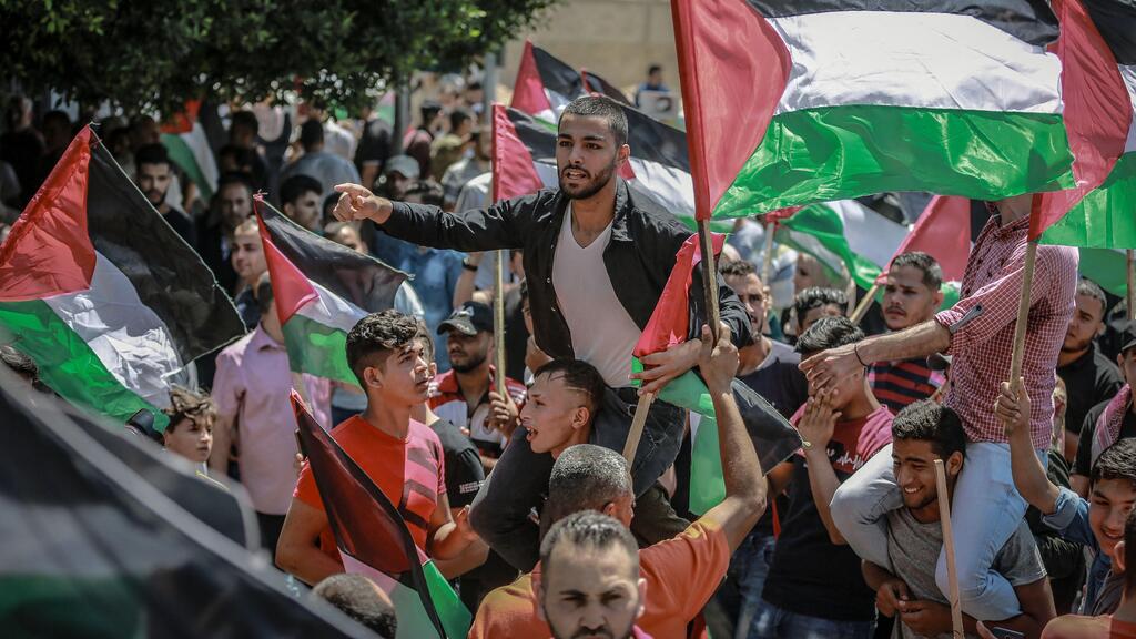 A Palestinian demonstrator shouts slogans as he takes part in a protest against Israel's annexation plan, July 1, 2020 