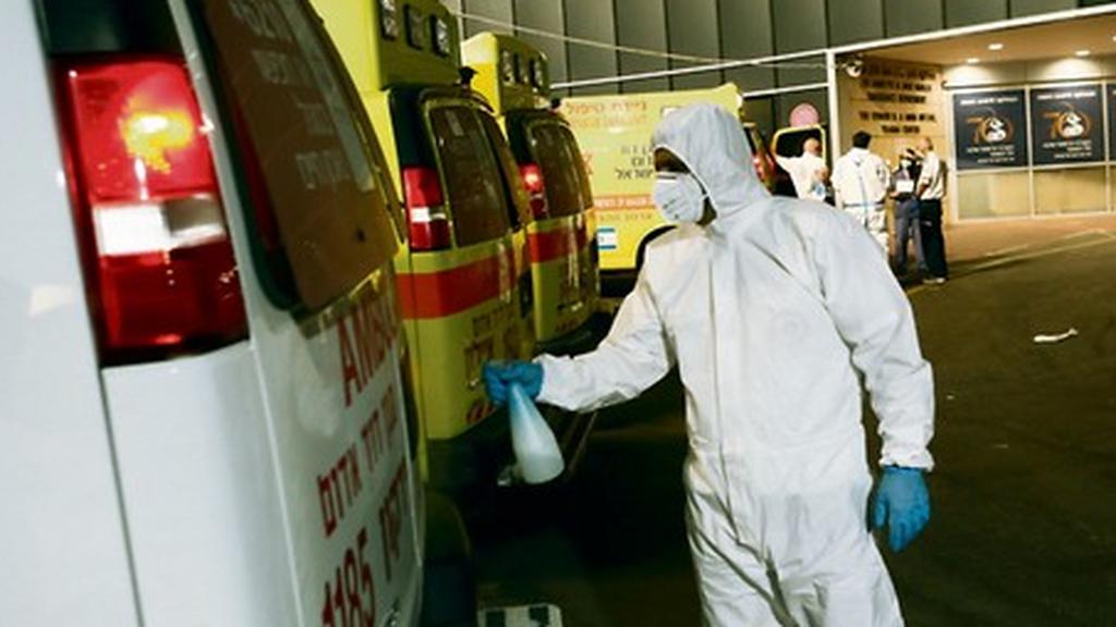 A Magen DAvid Adom staffer disinfects an ambulance used for coronavirus cases 