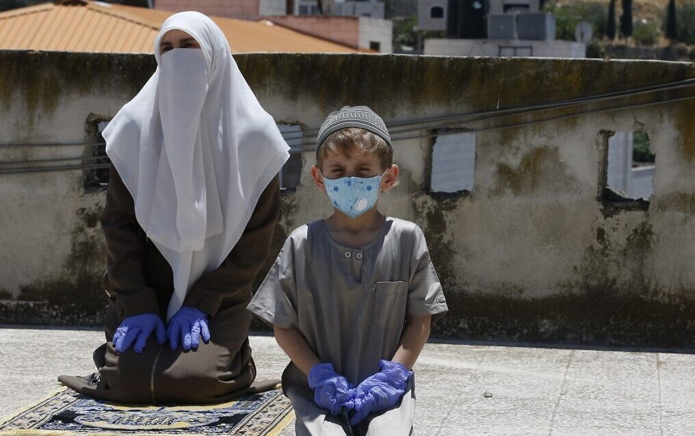 Palestinians with masks to protect against coronavirus in hard-hit Hebron on the West Bank (Photo: AFP) Palestinians with masks to protect against coronavirus in hard hit Hebron on the West Bank
